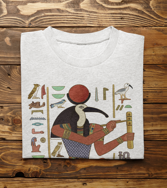 Thoth T-Shirt folded on wood surface with Egyptian heiroglyphics design